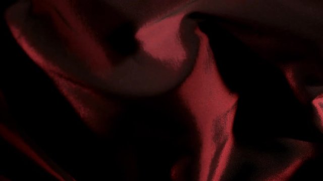 Red wavy fabric background in super slow motion, 4K