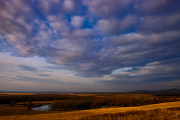 River in autumn field