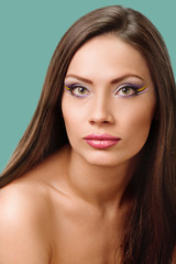 Fototapeta premium beautiful girl looking to the camera. shoulder portrait on background jungle shade green color