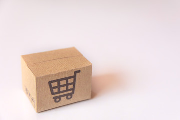 Cardboard box or parcel with supermarket cart logo on white background. with copy space