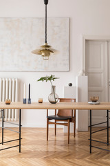 Eclectic and elegant dining room interior with design sharing table, chairs, gold pendant lamp,...