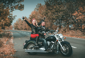Fototapeta na wymiar Happy bikers on motorcycle on the road.