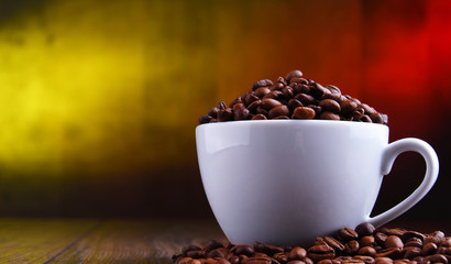 Composition with cup of coffee and beans