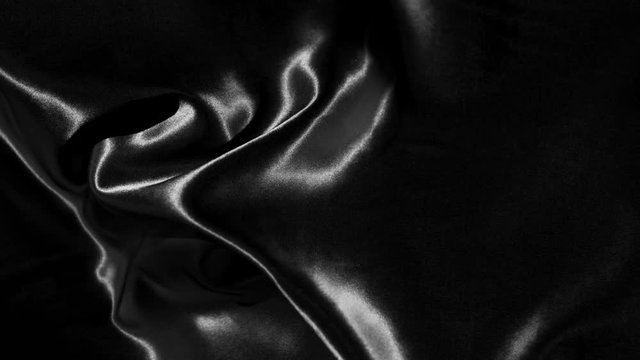 Black wavy fabric background in super slow motion, 4K