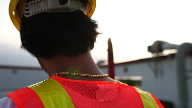 Concept Labor Day: Labor man holding a pipe wrench with the warm light of the Sunset footage slow motion 