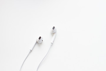 white wired headphones isolated on white background
