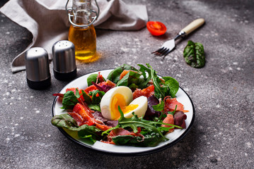 Healthy salad with prosciutto, tomato and egg