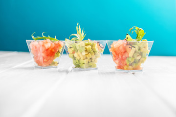 Delicious salads with avocado and tomato in cups. Concept for food, diet, healthy food, restaurant and catering.