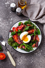 Healthy salad with prosciutto, tomato and egg