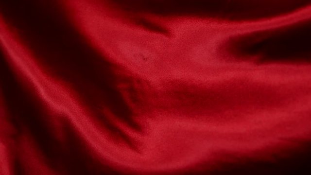 Red wavy fabric background in super slow motion, 4K