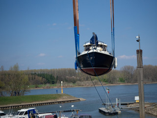fishing boat in the harbour on a crane
