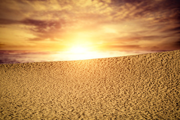 Summer background of sand on beach and blue sky with sun light. Free space for your decoration. 