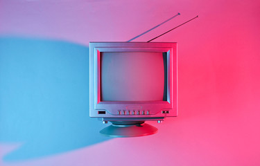 Retro wave, 80s. Old tv with antenna with neon light. Top view, minimalism - obrazy, fototapety, plakaty