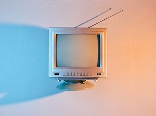 Retro wave, 80s. Old tv with antenna with neon light. Top view, minimalism