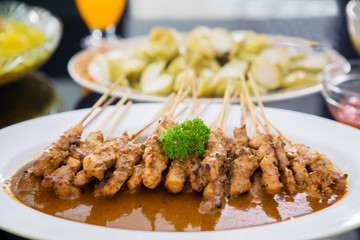 Plate filled with satay and peanut sauce