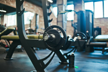 Fototapeta na wymiar Gym equipment. Dark Gym with barbells on rack. Fitness workout center. Sport concept.