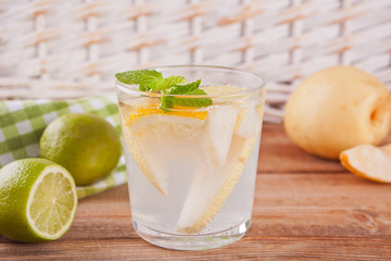 Pear Lemonade or mojito cocktail with pear, lemon and mint, cold refreshing drink or beverage