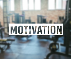 Obraz premium Word Motivation on blurred background of gym with equpment.