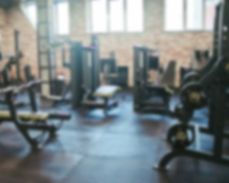 Blurred photo of the interior with gym equipment. Sports concept, workout