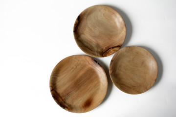 Empty wooden plates on a light background with spikelets