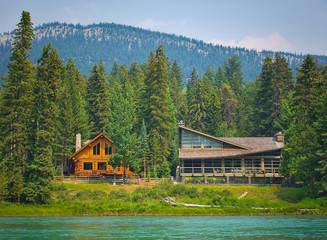 Two styles of wooden house commonly found near lakes and rivers. Rocky mountain ( Canadian Rockies...
