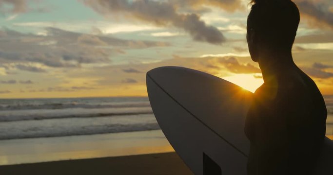 Portrait of surfer looking at waves