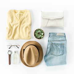 Woman clothes and accessories set on white background top view. modern and casual outfit. fashion, shopping and makeup concept. Flat lay, top view. 