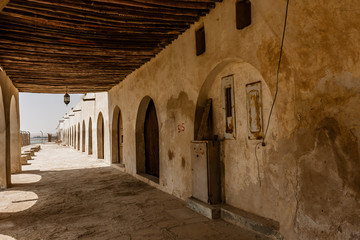The covered passage at the facade of Aqeer Castle, Saudi Arabia