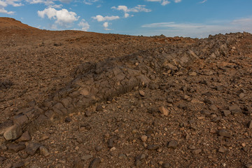 Fototapeta na wymiar Lava outcrops on the slope of the Al Wahbah volcanic crater, Saudi Arabia