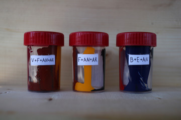 Color colorants in plastic cans with letter symbols.
