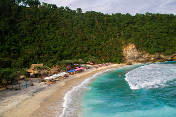 2018_1_19 Nusa Penisa, BALI. Aerial or Top view of colorful Atuh beach. Turquoise water, white sand beach, warm sunlight, sun loungers and parasols. Tourist popular destination/attraction in Indonesia