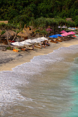 2018_1_19 Nusa Penisa, BALI. Aerial or Top view of colorful Atuh beach. Turquoise water, white sand beach, warm sunlight, sun loungers and parasols. Tourist popular destination/attraction in Indonesia