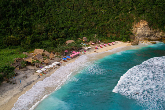 2018_1_19 Nusa Penisa, BALI. Aerial or Top view of colorful Atuh beach. Turquoise water, white sand beach, warm sunlight, sun loungers and parasols. Tourist popular destination/attraction in Indonesia