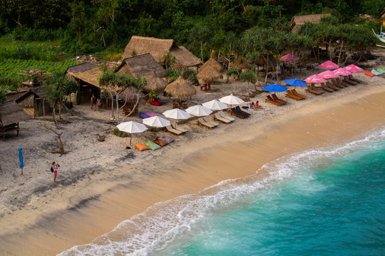 2018_1_19 Nusa Penisa, BALI. Aerial or Top view of colorful Atuh beach. Turquoise water, white sand beach, warm sunlight, sun loungers and parasols. Tourist popular destination/attraction in Indonesia