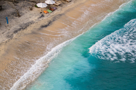 2018_1_19 Nusa Penisa, BALI. Aerial or Top view of colorful Atuh beach. Turquoise water, white sand beach, warm sunlight, sun loungers and parasols. Tourist popular destination/attraction in Indonesia