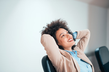 Beautiful and calm business woman sitting at a table in office.