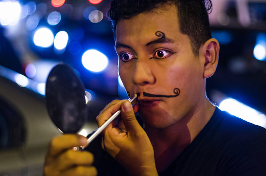 Portrait Of A Young Clown Putting On Mustaches With Makeup