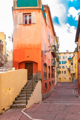 Nice in France, small street with typical colorful facade in the old town