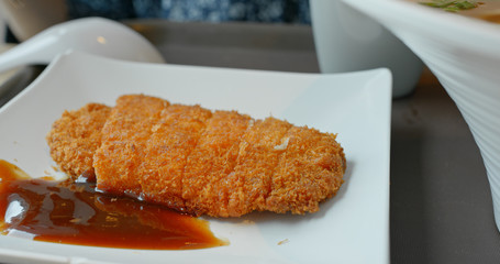 Woman eat tonkatsu in restaurant