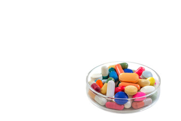 Colorful medical capsules in Petri dishes. Laboratory concept on white
