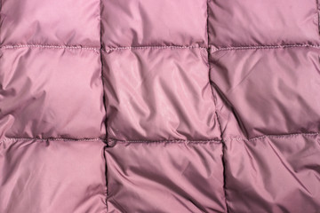 Textile and texture concept - closeup of crumpled pink fabric background