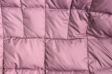 Textile and texture concept - closeup of crumpled pink fabric background