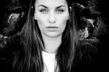 Black and white beautiful caucasian young woman portrait with clear blue eyes and serious expression