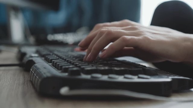 View of female hands typing on keyboard on blurred background
