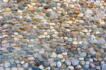 gray stone wall with yellow and blue splashes