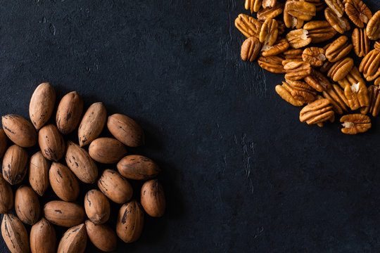 Natural pecan background pattern texture in-shell nuts, backdrop Pecans in shell top view