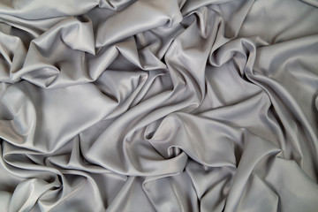  soft gray metallic fabric lined with waves and folds, drapery