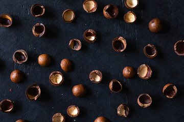 Top view of background texture of fresh natural shells of macadamia nuts, full frame and flat lay