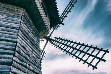 Old wooden windmill against the blue sky in the countryside