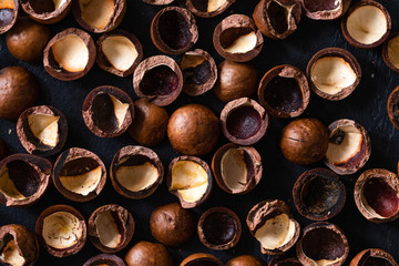 Top view of background texture of fresh natural shells of macadamia nuts, full frame and flat lay